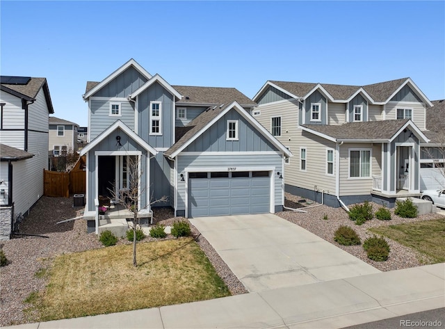 craftsman inspired home with fence, a shingled roof, board and batten siding, concrete driveway, and an attached garage