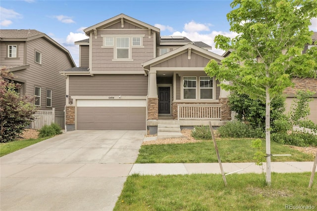 6484 N Ceylon Ct, Denver, CO 80249 - craftsman inspired home with stone siding, a porch, a garage, driveway, and board and batten siding