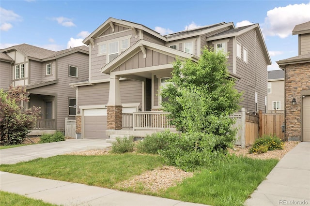 6484 N Ceylon Ct, Denver, CO 80249 - craftsman inspired home with board and batten siding, a porch, concrete driveway, an attached garage, and stone siding