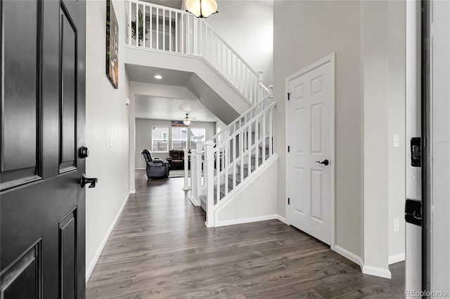 6484 N Ceylon Ct, Denver, CO 80249 - entrance foyer featuring baseboards, wood finished floors, stairway, a towering ceiling, and a ceiling fan