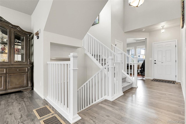 6484 N Ceylon Ct, Denver, CO 80249 - entrance foyer with wood finished floors, stairway, and baseboards