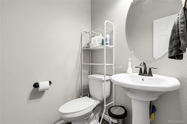 6484 N Ceylon Ct, Denver, CO 80249 - bathroom with toilet and a textured wall
