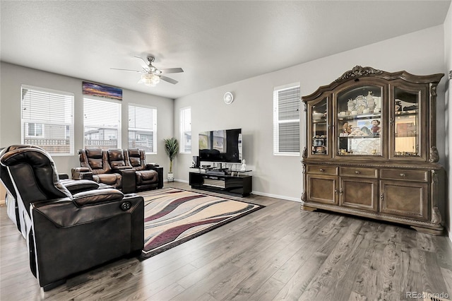 6484 N Ceylon Ct, Denver, CO 80249 - living area with ceiling fan, wood finished floors, and baseboards