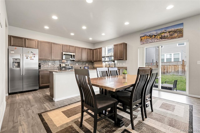 6484 N Ceylon Ct, Denver, CO 80249 - dining room featuring plenty of natural light, light wood-style flooring, and recessed lighting