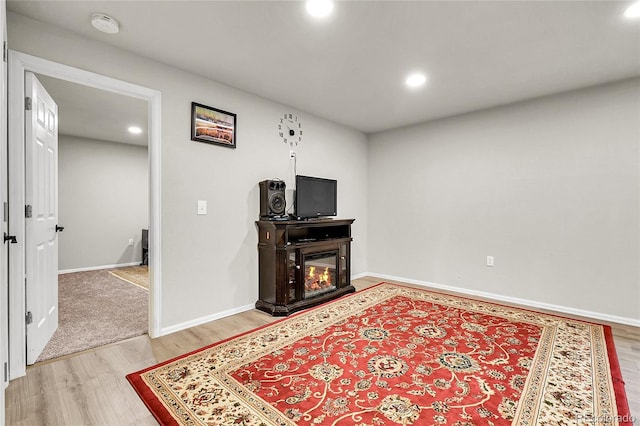 6484 N Ceylon Ct, Denver, CO 80249 - living room featuring light wood-style floors, recessed lighting, baseboards, and a glass covered fireplace