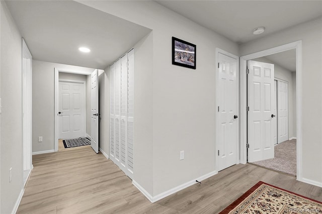 6484 N Ceylon Ct, Denver, CO 80249 - hall with light wood finished floors, baseboards, and recessed lighting