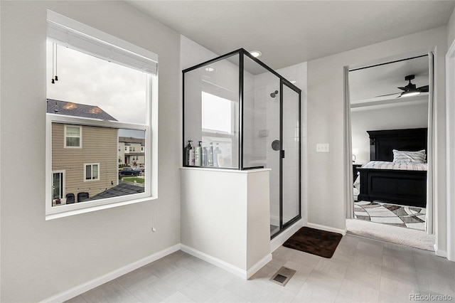 6484 N Ceylon Ct, Denver, CO 80249 - ensuite bathroom featuring a stall shower, baseboards, and ceiling fan