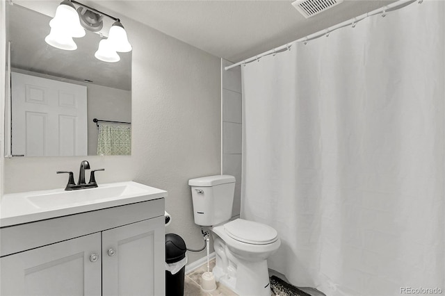 6484 N Ceylon Ct, Denver, CO 80249 - bathroom with toilet, vanity, baseboards, and a textured wall