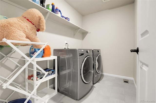 6484 N Ceylon Ct, Denver, CO 80249 - laundry room featuring washer and clothes dryer, baseboards, and light floors