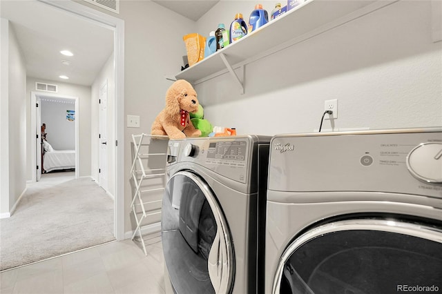 6484 N Ceylon Ct, Denver, CO 80249 - laundry area with separate washer and dryer, light colored carpet, and baseboards