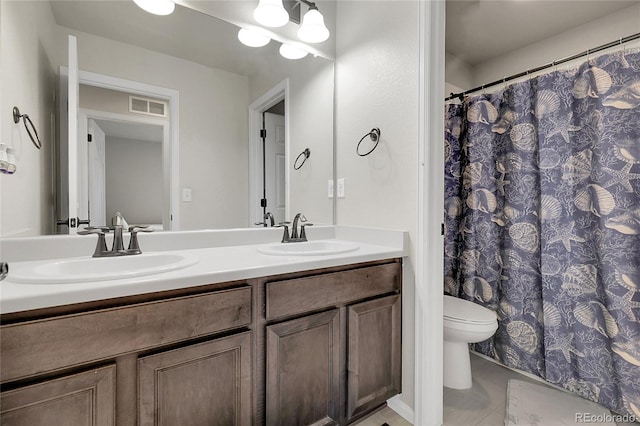 6484 N Ceylon Ct, Denver, CO 80249 - full bathroom featuring double vanity, toilet, tile patterned flooring, and a shower with shower curtain