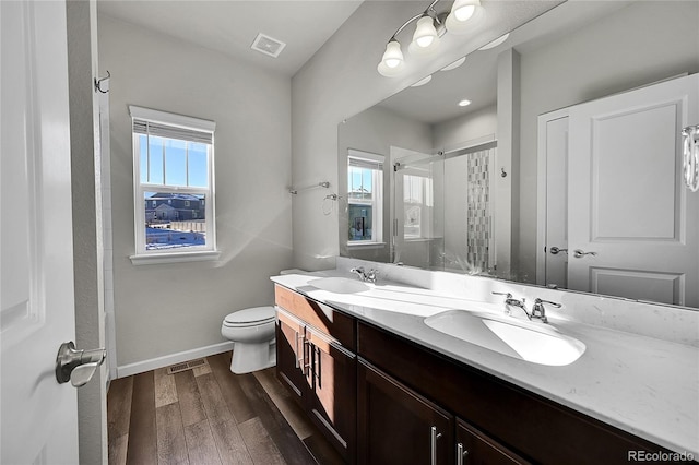 bathroom with vanity, toilet, an enclosed shower, and wood-type flooring