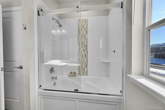 bathroom with plenty of natural light and combined bath / shower with glass door