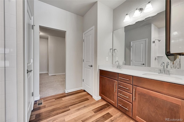 bathroom with vanity and hardwood / wood-style flooring