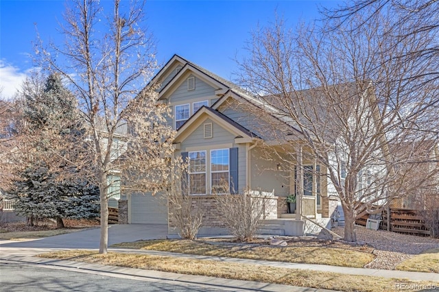 view of front of property featuring a garage, concrete driveway, and brick siding