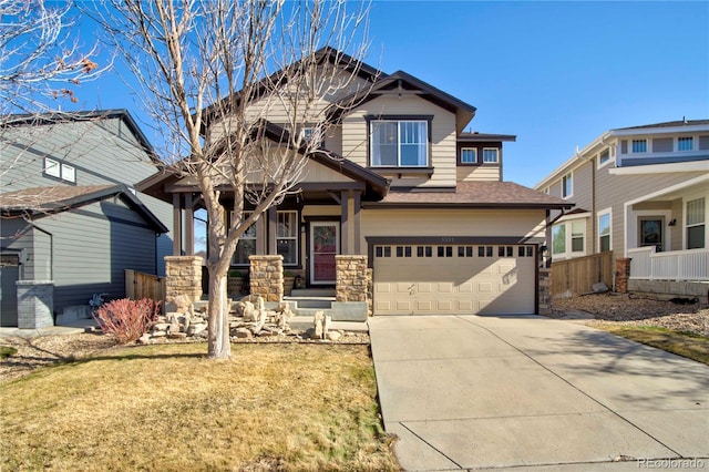 craftsman inspired home featuring a garage and a front lawn