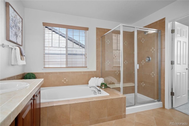 bathroom featuring tile patterned floors, plus walk in shower, and vanity