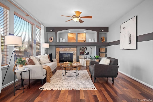 living room featuring dark hardwood / wood-style floors and ceiling fan