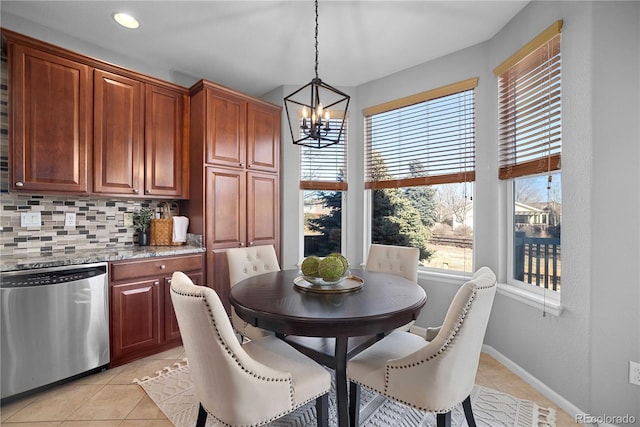 dining area featuring light tile patterned floors and a notable chandelier