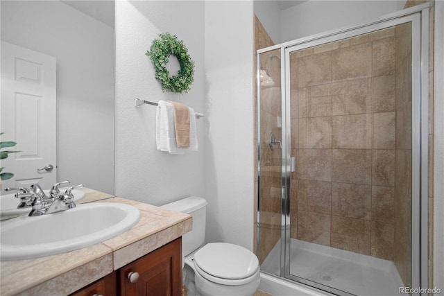 bathroom with walk in shower, vanity, and toilet