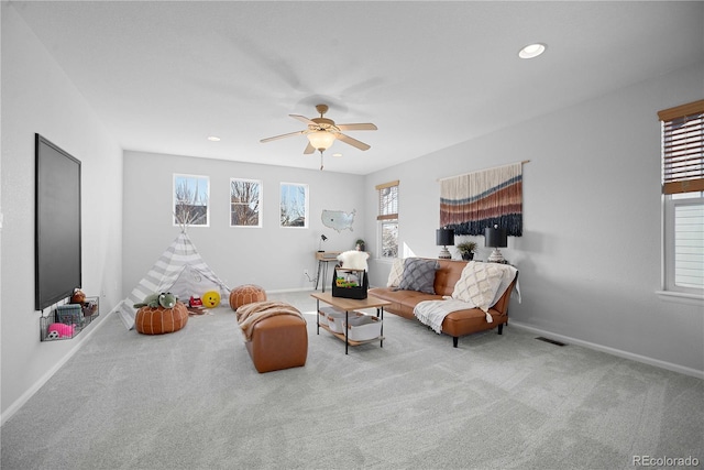 carpeted living room featuring ceiling fan