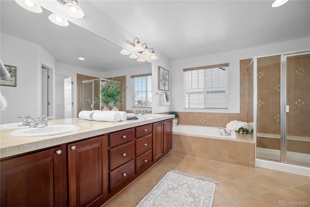 bathroom featuring shower with separate bathtub, tile patterned floors, and vanity