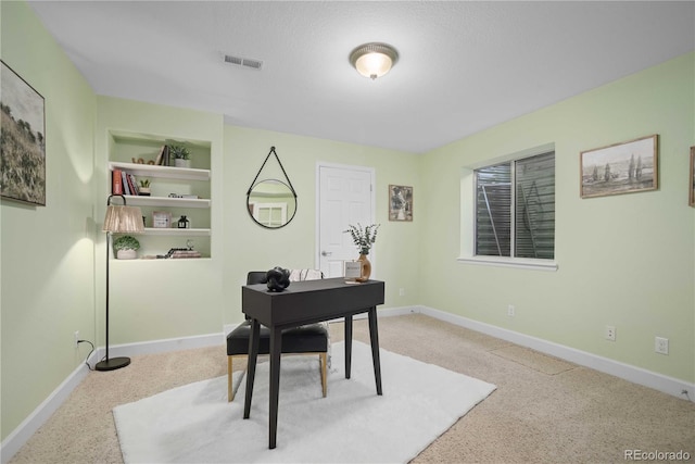 carpeted office with built in shelves