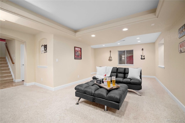 carpeted living room with a raised ceiling