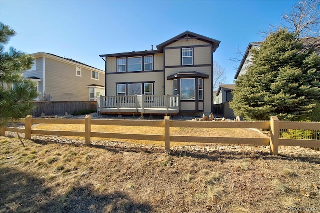 rear view of property featuring a deck