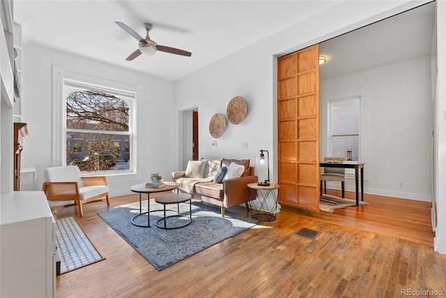 living room featuring ceiling fan and light wood-type flooring