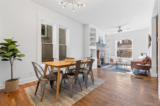 dining room featuring hardwood / wood-style floors and ceiling fan with notable chandelier