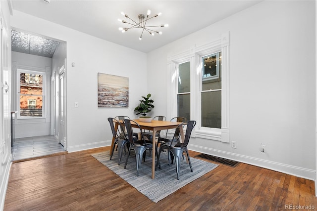 dining room featuring a chandelier and hardwood / wood-style floors