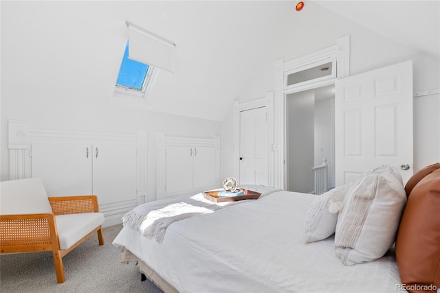 bedroom featuring carpet floors and vaulted ceiling with skylight