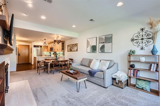 carpeted living room featuring sink