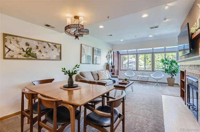 carpeted dining area with a fireplace