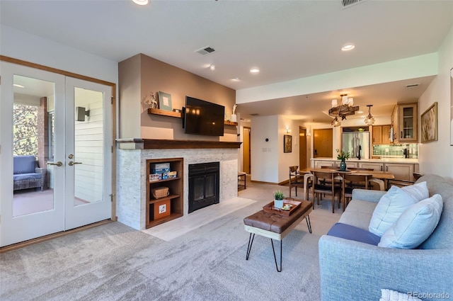 living room with french doors and light colored carpet