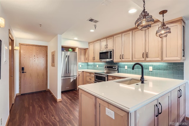 kitchen featuring sink, light brown cabinets, dark hardwood / wood-style flooring, pendant lighting, and stainless steel appliances