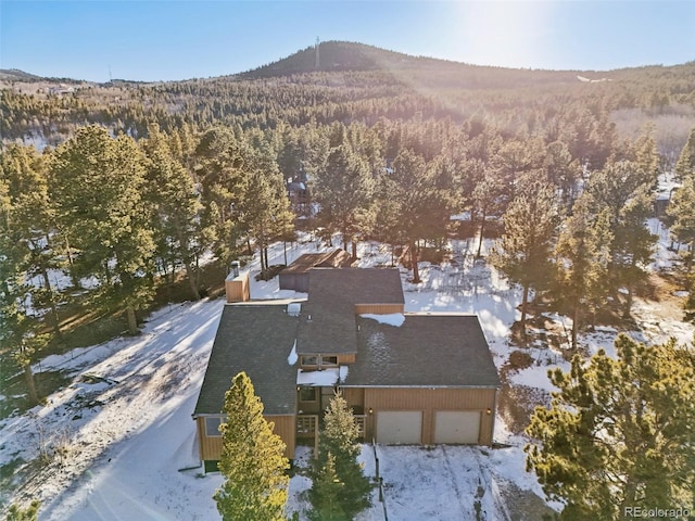 snowy aerial view with a mountain view