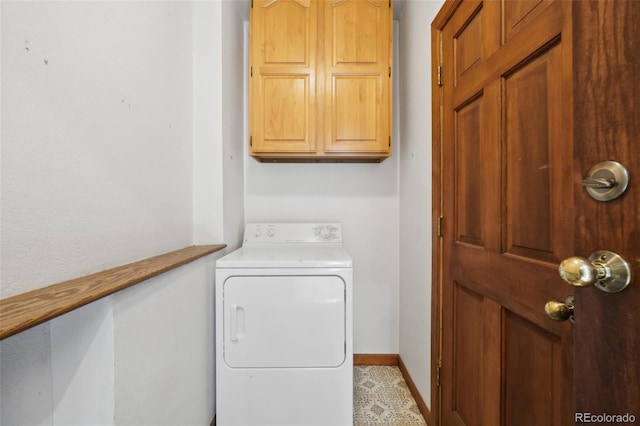 washroom with cabinets and washer / clothes dryer