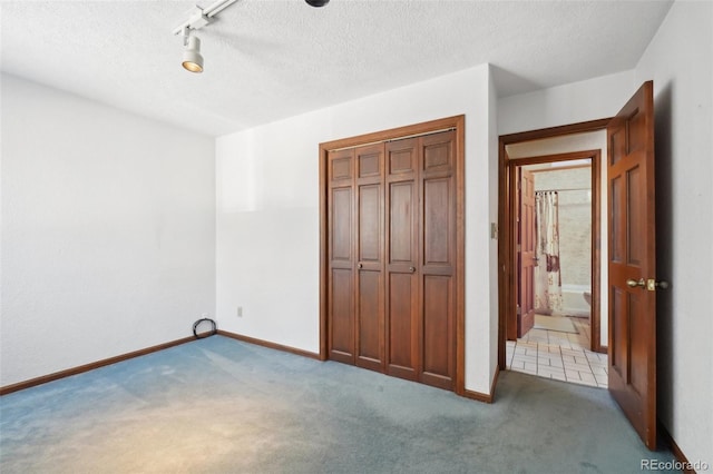 unfurnished bedroom featuring light carpet and a closet