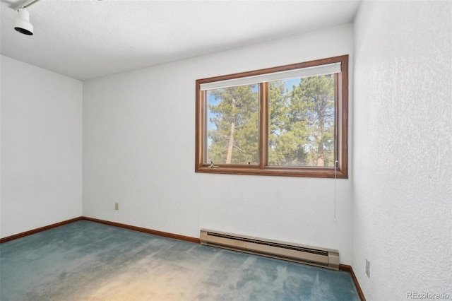 carpeted empty room featuring a baseboard radiator