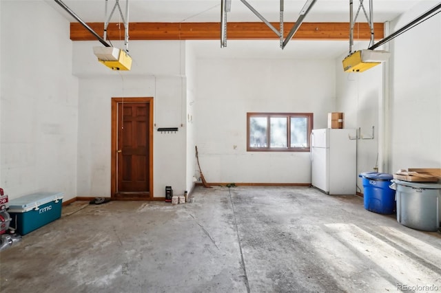 garage with a garage door opener and white refrigerator