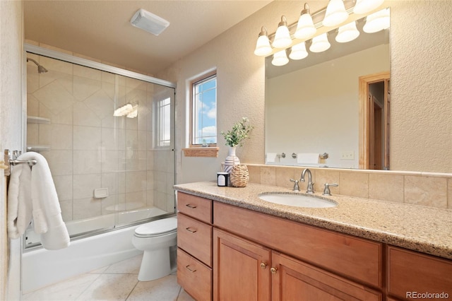 13909 Stone Chimney Ln, Pine, CO 80470 - bathroom featuring a textured wall, vanity, tile patterned flooring, and shower / bath combination with glass door