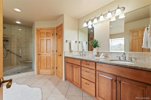 13909 Stone Chimney Ln, Pine, CO 80470 - full bath featuring double vanity, a shower stall, tile patterned flooring, and recessed lighting