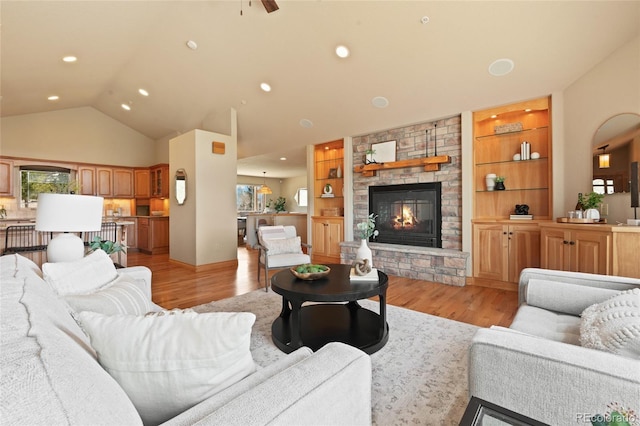 13909 Stone Chimney Ln, Pine, CO 80470 - living area with light wood finished floors, a fireplace, recessed lighting, high vaulted ceiling, and built in shelves