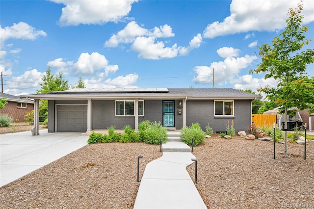 6066 Simms St, Arvada, CO 80004 - single story home featuring driveway, an attached garage, solar panels, brick siding, and a porch