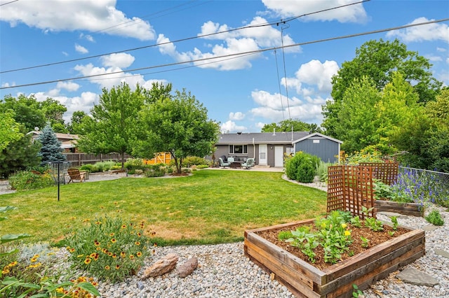 6066 Simms St, Arvada, CO 80004 - view of yard featuring a vegetable garden and a patio