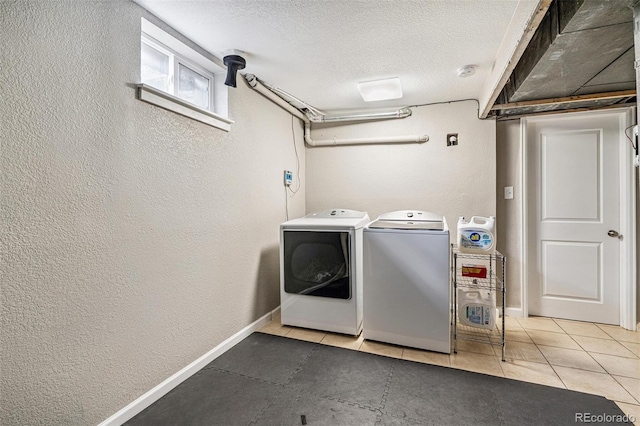 6066 Simms St, Arvada, CO 80004 - laundry area featuring a textured wall, a textured ceiling, separate washer and dryer, and tile patterned floors