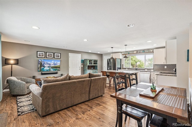 6066 Simms St, Arvada, CO 80004 - living room with light wood-style flooring and recessed lighting