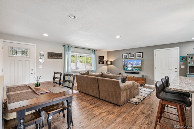 6066 Simms St, Arvada, CO 80004 - living room featuring wood finished floors, recessed lighting, and a textured ceiling